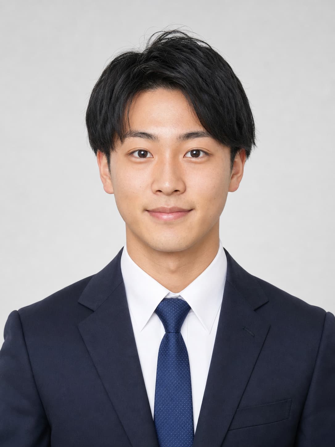 Professional resume portrait of a Japanese man in a navy suit